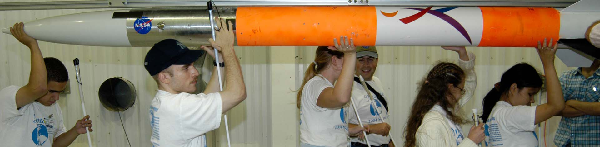 Blind students carry a rocket together while learning about Space