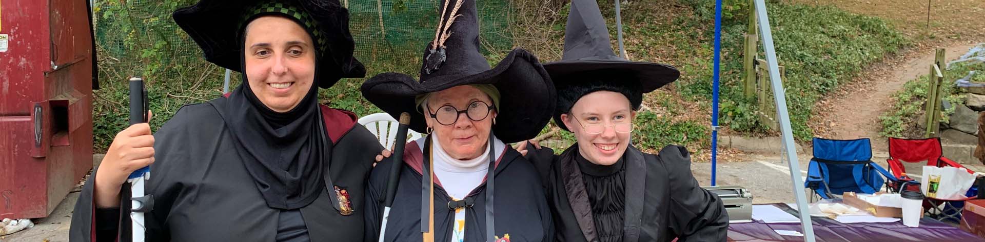 Three NFB of Maryland members smile at a Halloween themed Meet the Blind Month event