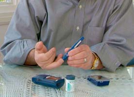 A close up view of a person using an insulin testing kit